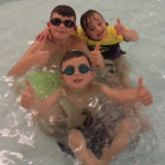 Children Swimming with thumbs up