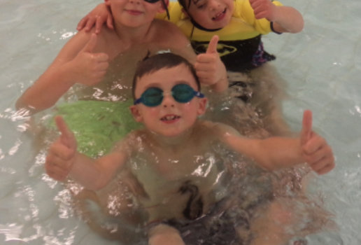 Children Swimming with thumbs up